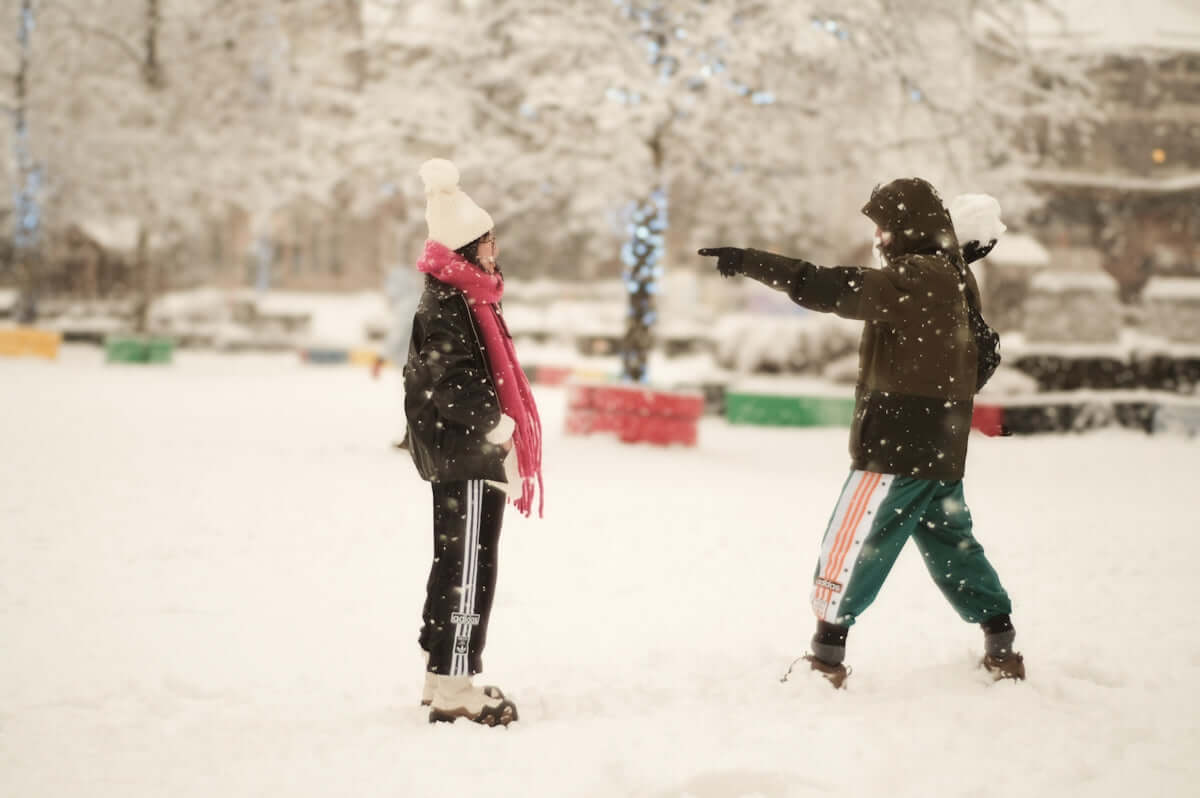 A couple of people that are standing in the snow